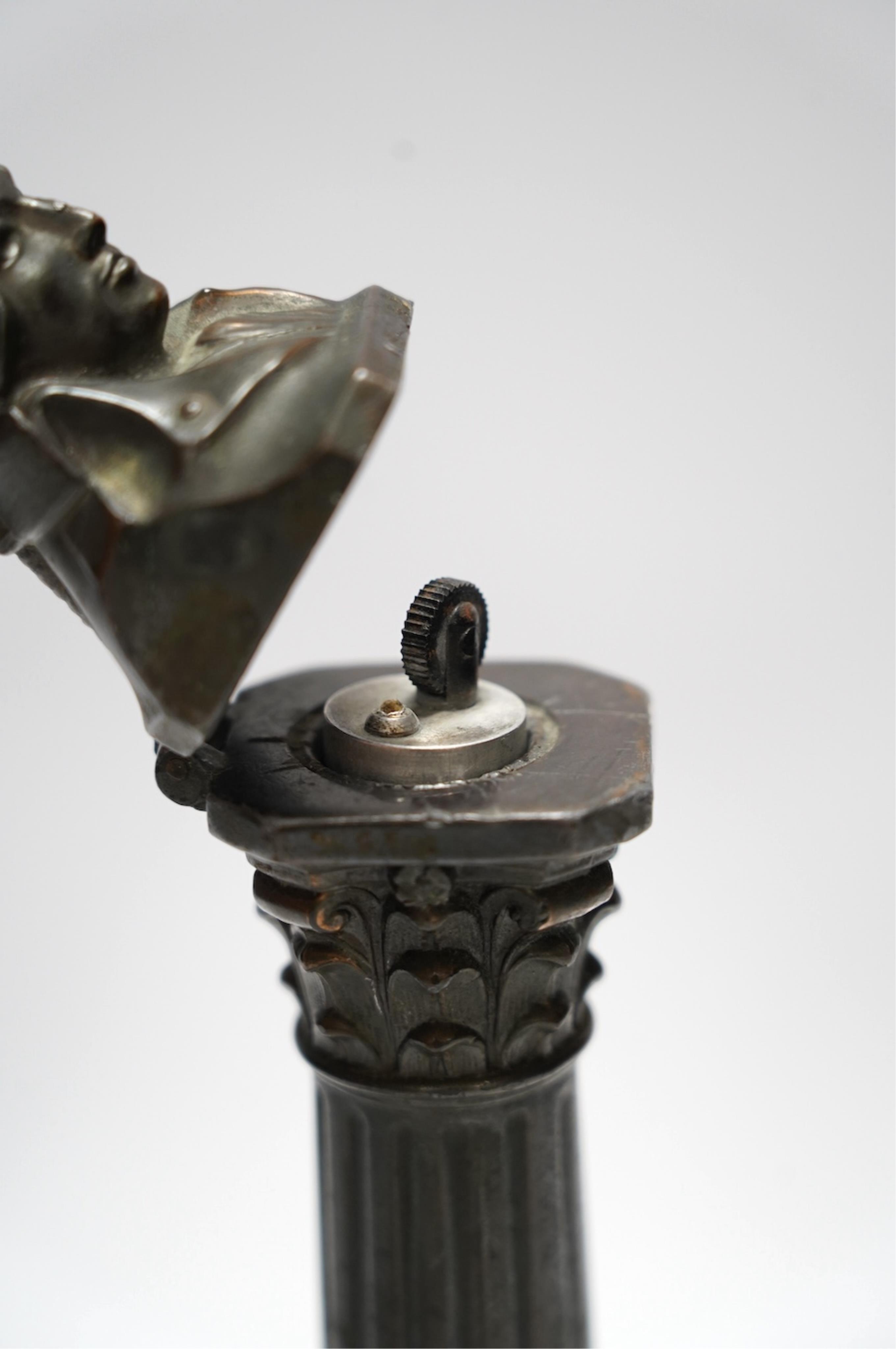A spelter bust of Lord Nelson on a column table lighter, 25cm high. Condition - poor to fair, hinge broken, untested